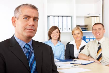 Business group at the meeting, mature man in front