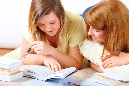 Beautiful girls learning; reading from books