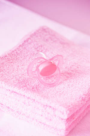 Pink baby dummy and towelsの写真素材