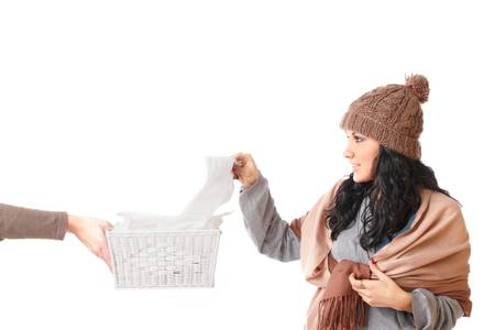 Young woman with a cold reaching out for a tissue の写真素材