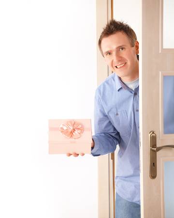 Man entering room with surprise giftの写真素材