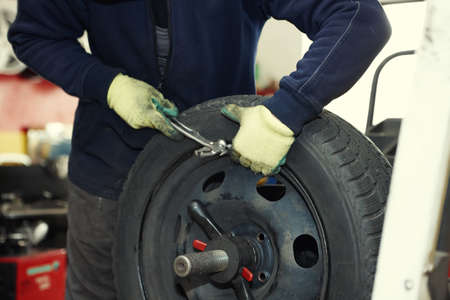 Professional auto mechanic balancing wheel before change itの写真素材