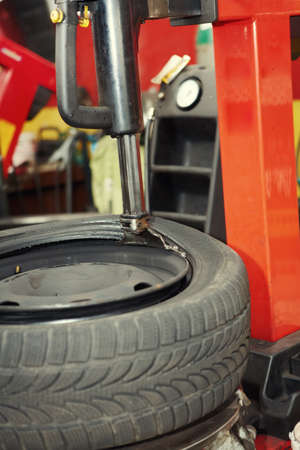 Changing a tire in auto repair shopの写真素材