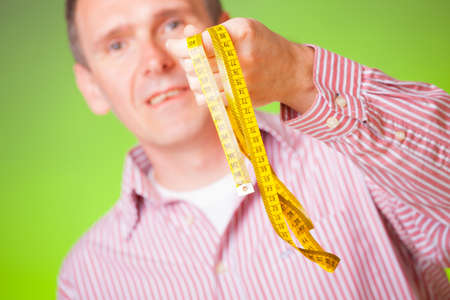 Man with tape measure, tailor, weight loss concept