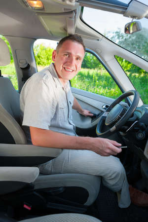 Man getting in or out the car with keys in hand