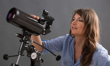 Beautiful woman with astronomical telescope