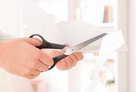 Woman cutting a paper