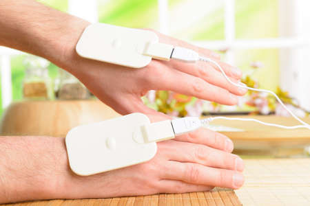 Electrotherapy, electrical stimulation using surface electrode pads with a conductor gel placed on...