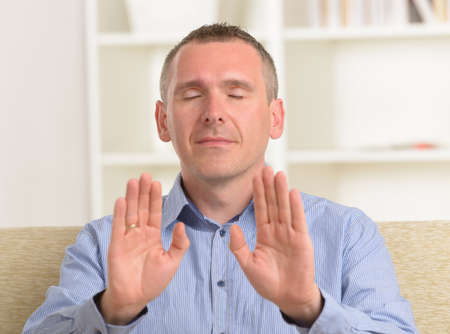 Man practicing Reiki transfering energy through palms, a kind of energy medicine の写真素材