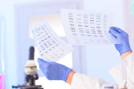 Scientist analizing DNA sequence for identityの写真素材