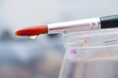 Paint brushesused by artists to create paintings on the jar with waterの写真素材