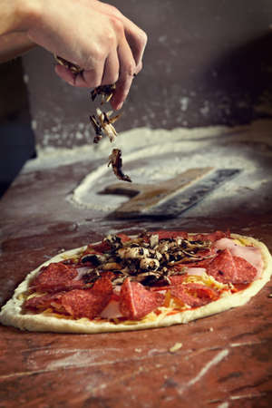 Fresh original Italian raw pizza, preparation in traditional style.の写真素材