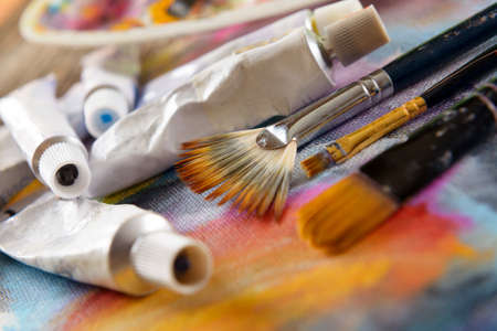 Professional acrylics paints with artistic brushes on canvasの写真素材