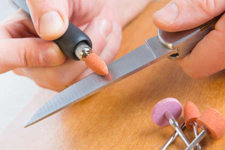 Using a high speed rotary multi tool to grinding a knife