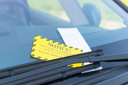 Parking ticket placed under windshield wiperの写真素材