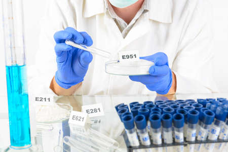 Researcher presenting preservatives substances that are added to products such as foods,...