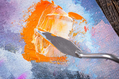 Acrylics paints on canvas with artistic putty knife on wooden boardの写真素材