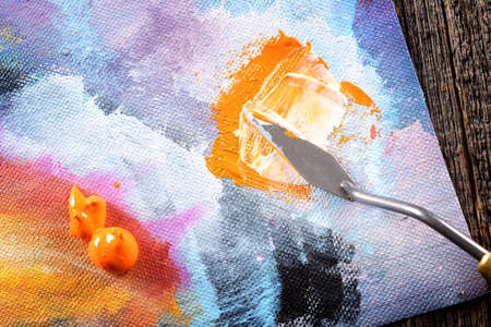Acrylics paints on canvas with artistic putty knife on wooden boardの写真素材