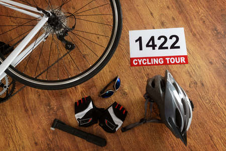 Rear bicycle wheel and other accessories on the wooden floorの写真素材