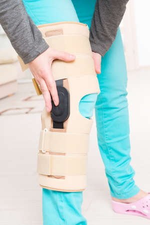 Woman's leg in knee cages for stabilization and supportの写真素材