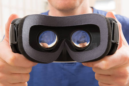 Man using virtual reality headset at home