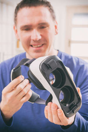 Man using virtual reality headset at home