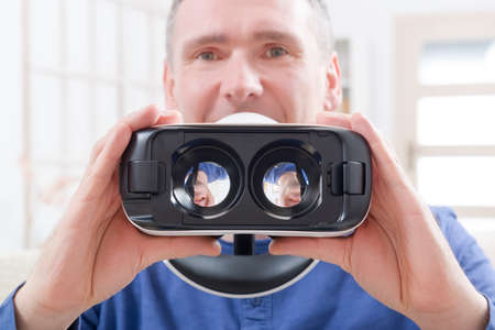 Man using virtual reality headset at home