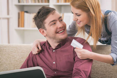 Happy couple doing on-line shopping with credit cardの写真素材