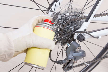 Preparing bicycle for a new season. Lubricating freewheel or cogwheelの写真素材