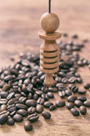 Using pendulum over coffee beans to check its qualityの写真素材