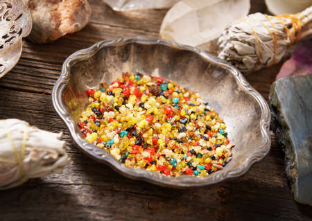 Natural loose incense in a silver bowl. Mix of ingredients like olibanum, styrax, herbs and white...