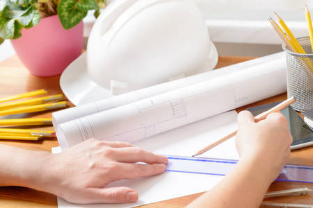 Architect at work. Construction plans, blueprint, measure, ruler and drawing tools 