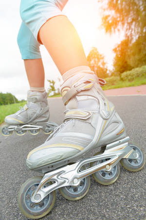 Woman on roller skates riding outdoorsの写真素材
