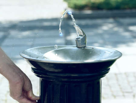 Drinking water flowing from a fountain in a city