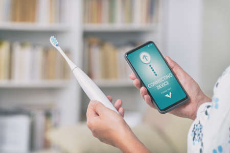 wireless connecting sonic toothbrush with smart phone app. Modern home technology conceptの写真素材
