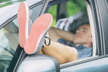 Man sleeping in the car before next part of the jurneyの写真素材