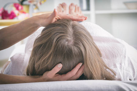 Professional Reiki healer doing reiki treatment to young womanの写真素材