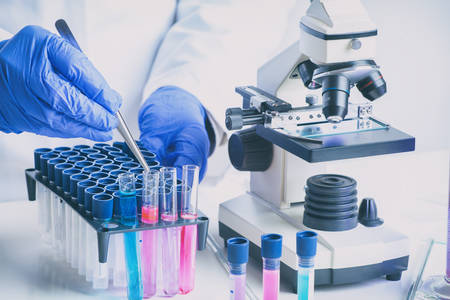Scientist with a test tube working at the laboratory, medical or chemistry research conceptの写真素材