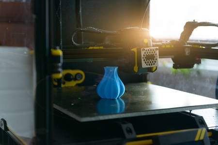 Modern 3d printer with printed three dimentional model of vase.の写真素材
