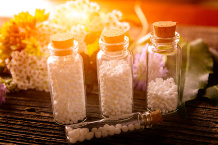 Homeopathic lactose sugar globules in glass bottles