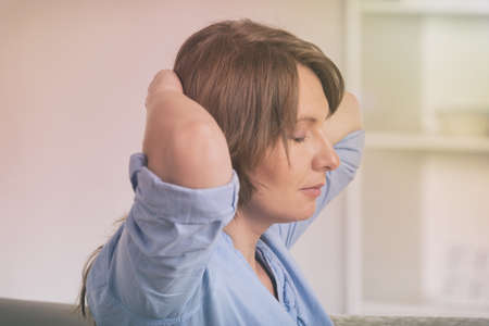 Woman practicing self Reiki transfering energy through palms, a kind of energy medicine.の写真素材