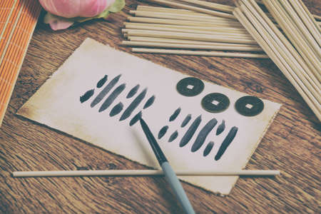 I ching ancient Chinese oracle with Yijing hexagram, old coins and stalksの写真素材