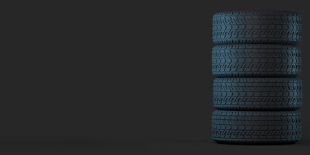 Four tires stacked on top of each other. Good graphics for use as a background or banner for a tire store, storage room, tire service. 3d illustration on darkの写真素材