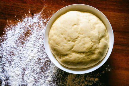 Preparing dough for white bread, rolls, pizza. Yeast dough in a bowl made from wheat flour.の写真素材