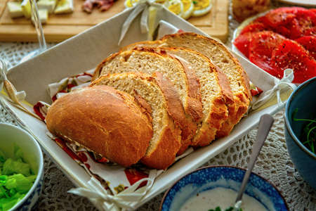 A loaf of bread cut into slices. A continental, healthy breakfast containing homemade bread and a...