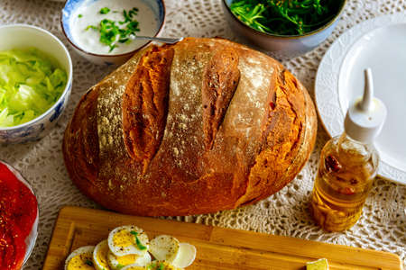 Continental, healthy breakfast containing homemade bread, vegetables tomatoes, argula, salad and...