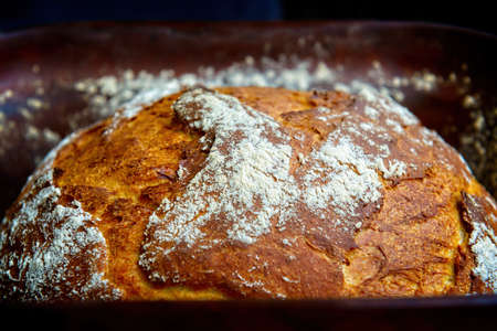 Traditional wheat and rye bread baked at home in a clay pot known as a Roman pot