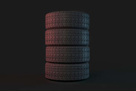 Four tires stacked on top of each other  over dark gray background. Good graphic for a tire store,...