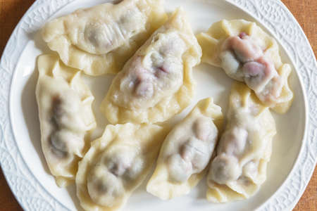 Fresh dumplings with cherry filling on a plateの写真素材