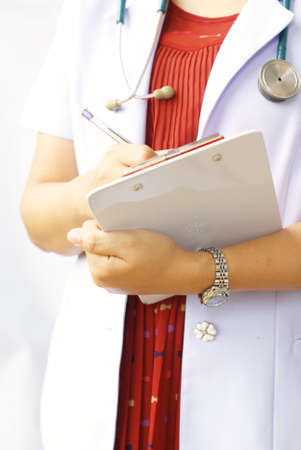 doctor writing on clipboardの写真素材